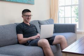 image tagged with computer, looks, male, sofa, glasses, …;
