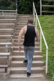 image tagged with climbs, man, stairs, male, glasses, …;