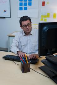 image tagged with glasses, guy, sit, works, computer, …;