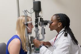 image tagged with slit lamp, females, medical device, eye exam, check up, …;