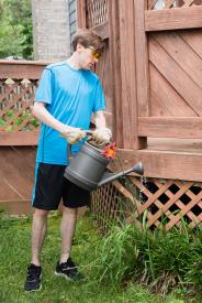 image tagged with garden, watering, waters, water, boy, …;