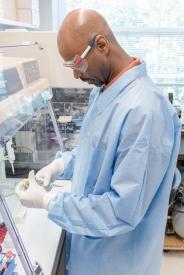 image tagged with african-american, scientist, coat, laboratory, rack, …;