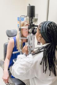 image tagged with women, eye exam, doctor, african-american, medical device, …;