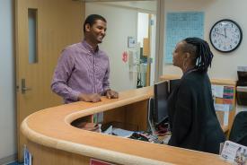 image tagged with african-american, doctor's office, man, patient, talk, …;