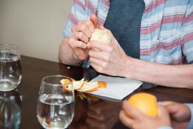 image tagged with table, hand, napkin, fruits, peels, …;
