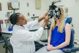 image tagged with medical device, african-american, check-up, vision, eye exam, …;