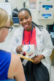 image tagged with african-american, patient, smiling, talks, doctor's office, …;