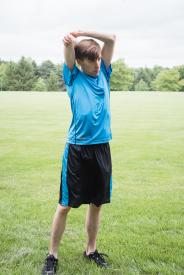image tagged with outside, field, stretch, park, boy, …;