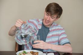 image tagged with pitcher, guy, water, eating, smile, …;
