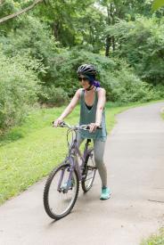 image tagged with female, glasses, exercise, ride, park, …;