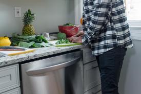 image tagged with leafy greens, male, counter, cutting board, pineapple, …;