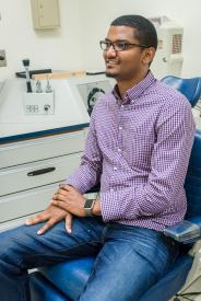 image tagged with sits, male, african-american, exam room, adult, …;