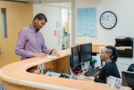 image tagged with lady, african-american, desk, doctor's office, man, …;