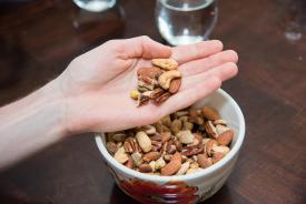 image tagged with bowl, holding, nut, eating, healthy food, …;