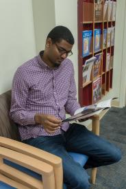 image tagged with waiting room, guy, sits, read, booklet, …;