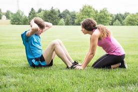 image tagged with couple, young, crunches, field, sit ups, …;