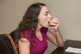 image tagged with chew, sitting, lady, apple, eat, …;
